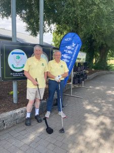 2 male golfer wearing yellow golf tops 