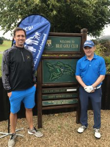 2 men wearing blue and navy golf clothes