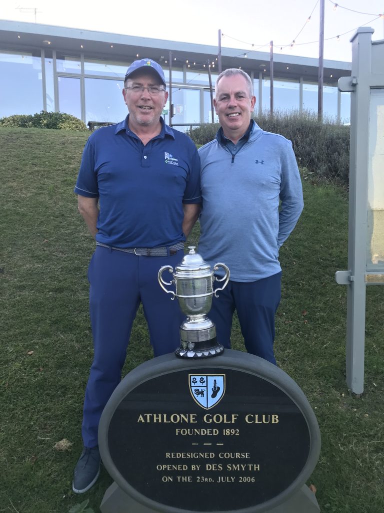 two men standing with tropy in front of Athlone Golf Club sign